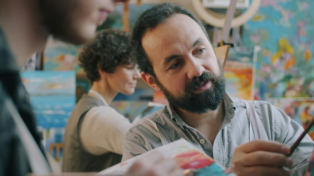 Team of three colleagues discussing around a table