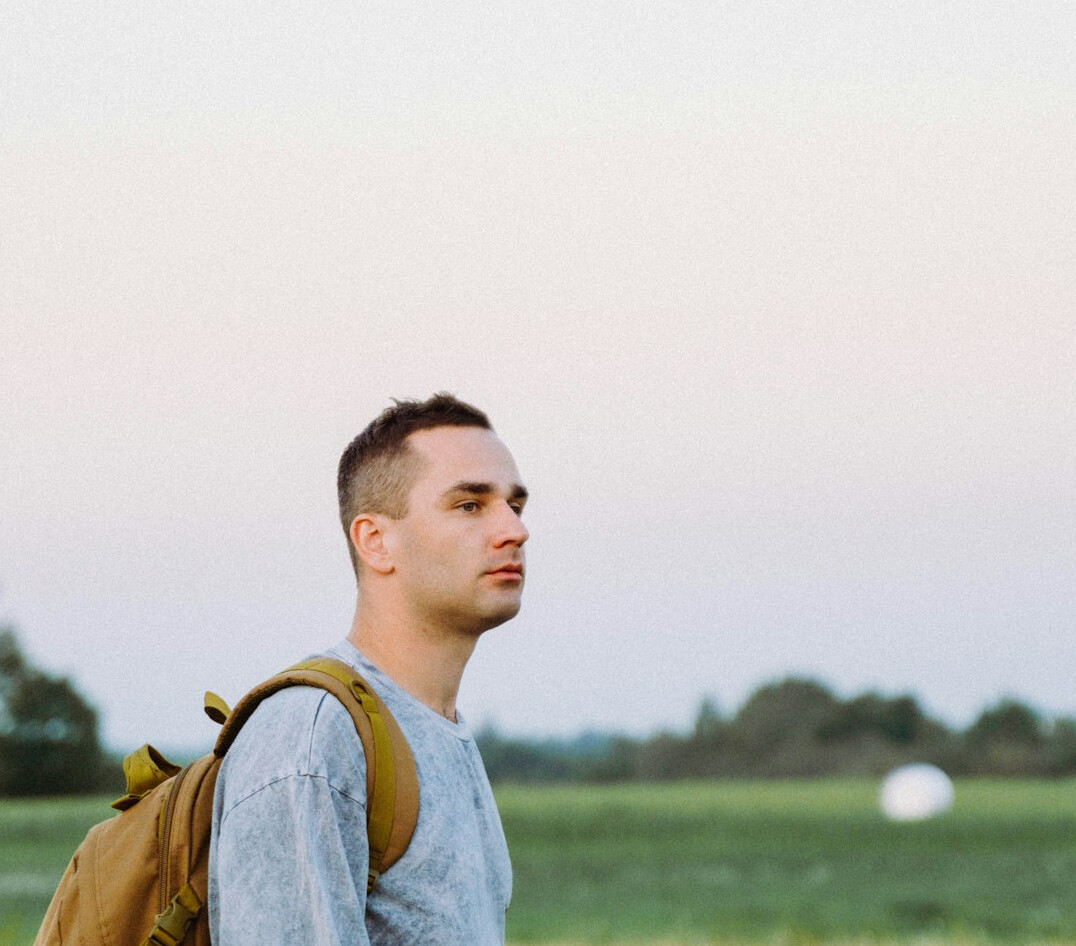 Young man in his twenties with backpack outdoors