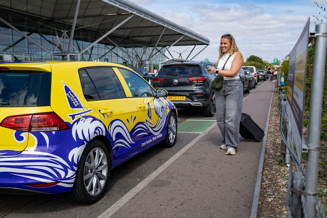 Woman with suitcase at an airport terminal