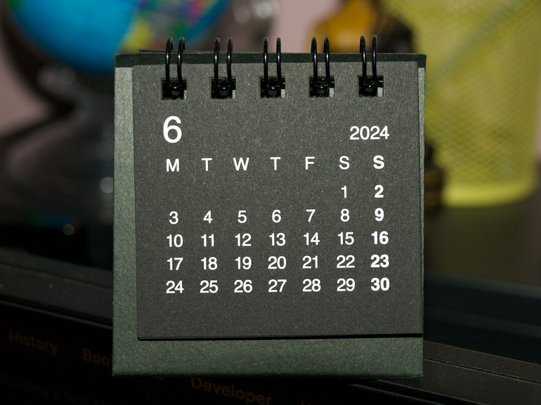 Calendar and pen on a wooden desk